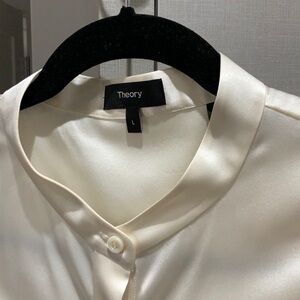 Beautiful ivory SILK, sleeveless blouse is stunning.  Never been worn, no tags.